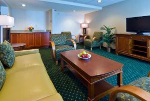 a waiting room with a couch and chairs and a table at Holiday Inn Cincinnati-Eastgate by IHG in Eastgate