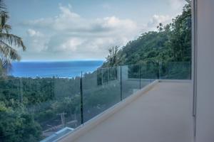 a view of the ocean from the balcony of a house at View Talay Samui in Lamai