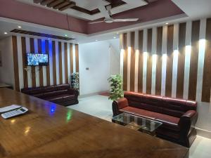 a conference room with leather chairs and a table at HOTEL AL SAFA INTERNATIONAL, Ashkona in Dhaka