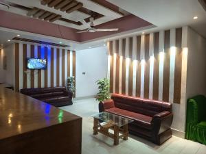 a living room with a couch and a table at HOTEL AL SAFA INTERNATIONAL, Ashkona in Dhaka +21 photos