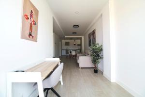 a dining room with white walls and a table and chairs at Apartamentos turísticos El Pinar in Mogro