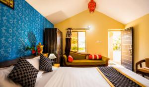 a bedroom with a bed and a couch at Desert Luxury Camp & Resort Jaisalmer in Jaisalmer
