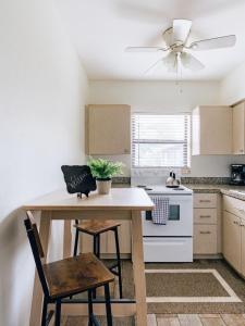 a kitchen with a table and a ceiling fan at Studio in Pompano Beach two blocks from the Ocean in Pompano Beach