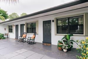 a house with two chairs and a door at Studio in Pompano Beach two blocks from the Ocean in Pompano Beach
