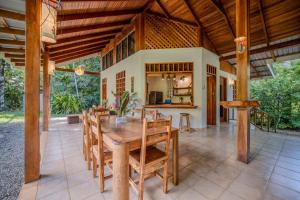 a dining room with a wooden table and chairs at Osos Caribeños - with Garden - 400m from the Beach in Punta Uva