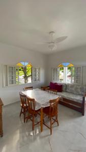 a living room with a table and a couch at Residencial Sombreiro - a 50 m da praia in Florianópolis