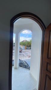 an open door to a balcony with a view of a street at Residencial Sombreiro - a 50 m da praia in Florianópolis