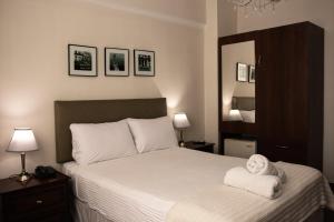 a bedroom with a bed with a towel on it at Kontiki Miraflores in Lima +25 photos