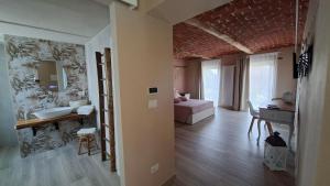a living room with a sink and a mirror at San Lorenzo Suite in Tigliole +13 photos