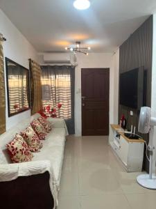 a living room with a couch and a television at Vin's Transient WiFi Netflix City Hall-DRMC-EPark in Tagum