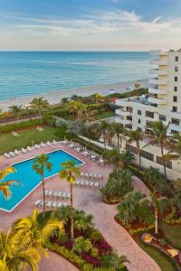 an aerial view of a resort with a pool and the ocean at Holiday Inn Miami Beach-Oceanfront by IHG in Miami Beach