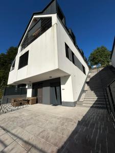 a large white building with stairs in front of it at Apartments near Ljubljana, Sleeps 10, Free Parking in Škofljica