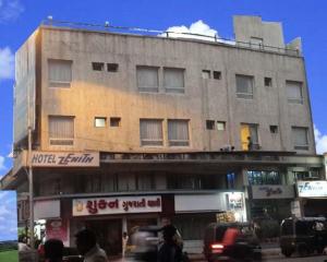 um edifício com pessoas a andar na frente dele em Hotel Zenith em Surat