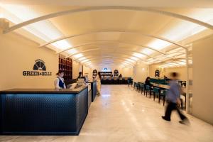 a long hallway with people walking through a building at ANA Crowne Plaza Hotel Nagasaki Gloverhill by IHG in Nagasaki
