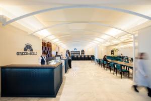 a rendering of the lobby of a library with people sitting at tables at ANA Crowne Plaza Hotel Nagasaki Gloverhill by IHG in Nagasaki