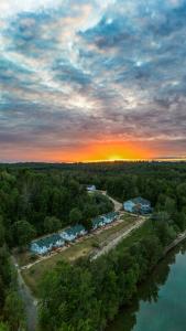 an aerial view of a town with a river and houses at Pimishka Chalet-Cottage-Studios in Bouchette