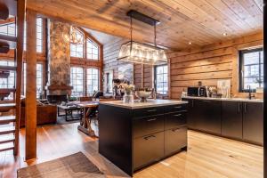a kitchen with wooden walls and a wooden ceiling at Idre Luxury Chalet Winter Haven /w Sauna - Happy Rentals in Idre