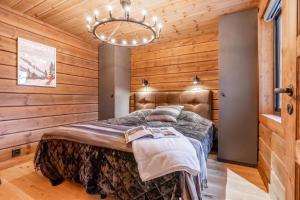 a bedroom with a bed in a wooden wall at Idre Luxury Chalet Winter Haven /w Sauna - Happy Rentals in Idre