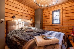 a bedroom with a bed in a wooden cabin at Idre Luxury Chalet Winter Haven /w Sauna - Happy Rentals in Idre