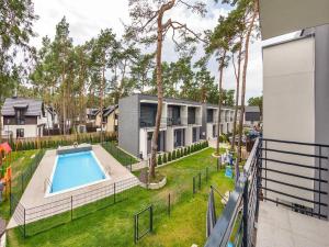 an apartment with a backyard with a swimming pool at Comfortable holiday home with a garden and a pool in Pobierowo
