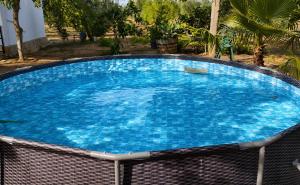 a large swimming pool with blue water at El Paraíso Del Olivar in Bollullos de la Mitación