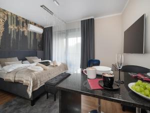 a bedroom with a bed and a dining area with a table at Holiday studio with balcony, indoor pool, sauna in Polanica-Zdrój +41 photos