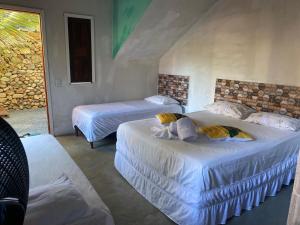 a bedroom with two beds and a window at Sítio com suítes e áreas de Lazer in Palmeiras +85 photos