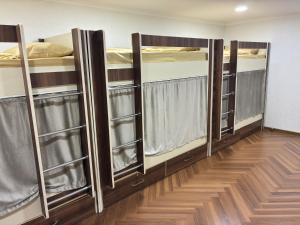 a row of bunk beds in a room at KING City Center Hostel in Baku