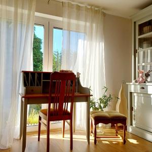 a desk and a chair in a room with a window at Ferienwohnung Stadt-Land-Fluss in Bad Salzuflen +88 photos