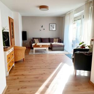 a living room with a couch and a table at Ferienwohnung Stadt-Land-Fluss in Bad Salzuflen