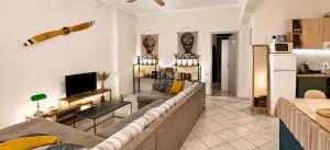a living room with a couch and a kitchen at Deodonum Luxury Apartments in Heraklio