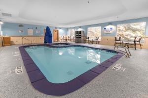 a large swimming pool in a hotel room at Holiday Inn Express Salt Lake City South - Midvale by IHG in Midvale