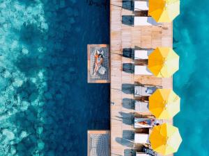 an overhead view of a dock with chairs and umbrellas at The Bodrum Hotel Yalıkavak - MGallery Collection in Yalıkavak
