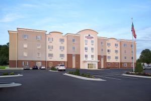 a large building with cars parked in a parking lot at Candlewood Suites North Little Rock by IHG in North Little Rock