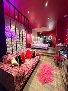 a living room with a couch and a bedroom at Suite Jacuzzi & Sauna privatifs - Paris - Or Norme By Le Douze in Paris