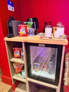 a refrigerator filled with food on top of a table at Suite Jacuzzi & Sauna privatifs - Paris - Or Norme By Le Douze in Paris +23 photos
