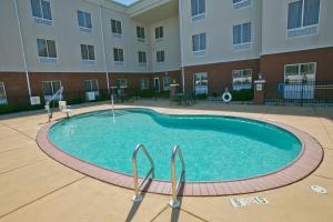 a large swimming pool in front of a building at Holiday Inn Express & Suites Brookhaven by IHG in Brookhaven