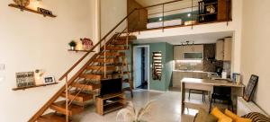 a spiral staircase in a living room with a kitchen at Deodonum Luxury Apartments in Heraklio