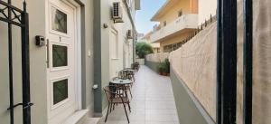 a corridor with tables and chairs in a building at Deodonum Luxury Apartments in Heraklio