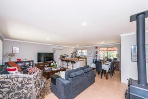 a living room with a couch and a fireplace at Waves And Moore - Beautifully presented home in Guilderton