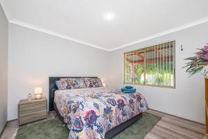 a bedroom with a bed and a window at Waves And Moore - Beautifully presented home in Guilderton