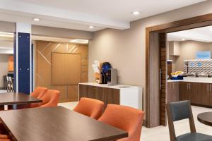 a dining room with tables and orange chairs at Holiday Inn Express - Bowling Green by IHG in Bowling Green