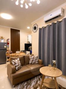 a living room with a couch and a table at Cozy Home in Dipolog by Aveinz in Dipolog