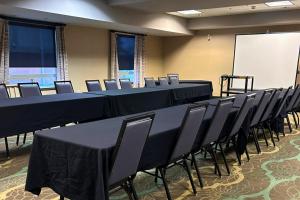 a conference room with tables and chairs and a whiteboard at Holiday Inn Express Fort St John by IHG in Fort Saint John +40 photos