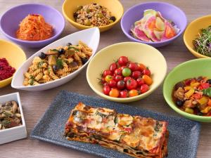 a table topped with bowls of different types of food at Mercure Saga Karatsu Resort in Karatsu