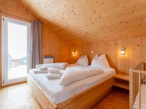 a bedroom with a bed in a wooden cabin at Das Edelweiss in Hohentauern +39 photos