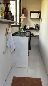 a small kitchen with a sink and a counter at Casa do Val in Fernando de Noronha