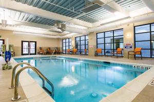 a pool in a hotel with chairs and tables at Holiday Inn & Suites Chattanooga Downtown by IHG in Chattanooga