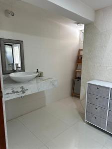 a white bathroom with a sink and a mirror at Playa Ziba in Ciudad del Carmen +38 photos