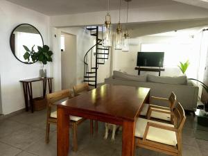 a living room with a table and a couch at Playa Ziba in Ciudad del Carmen